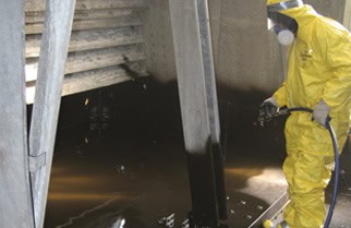 man in HAZMAT suit repairing cooling system